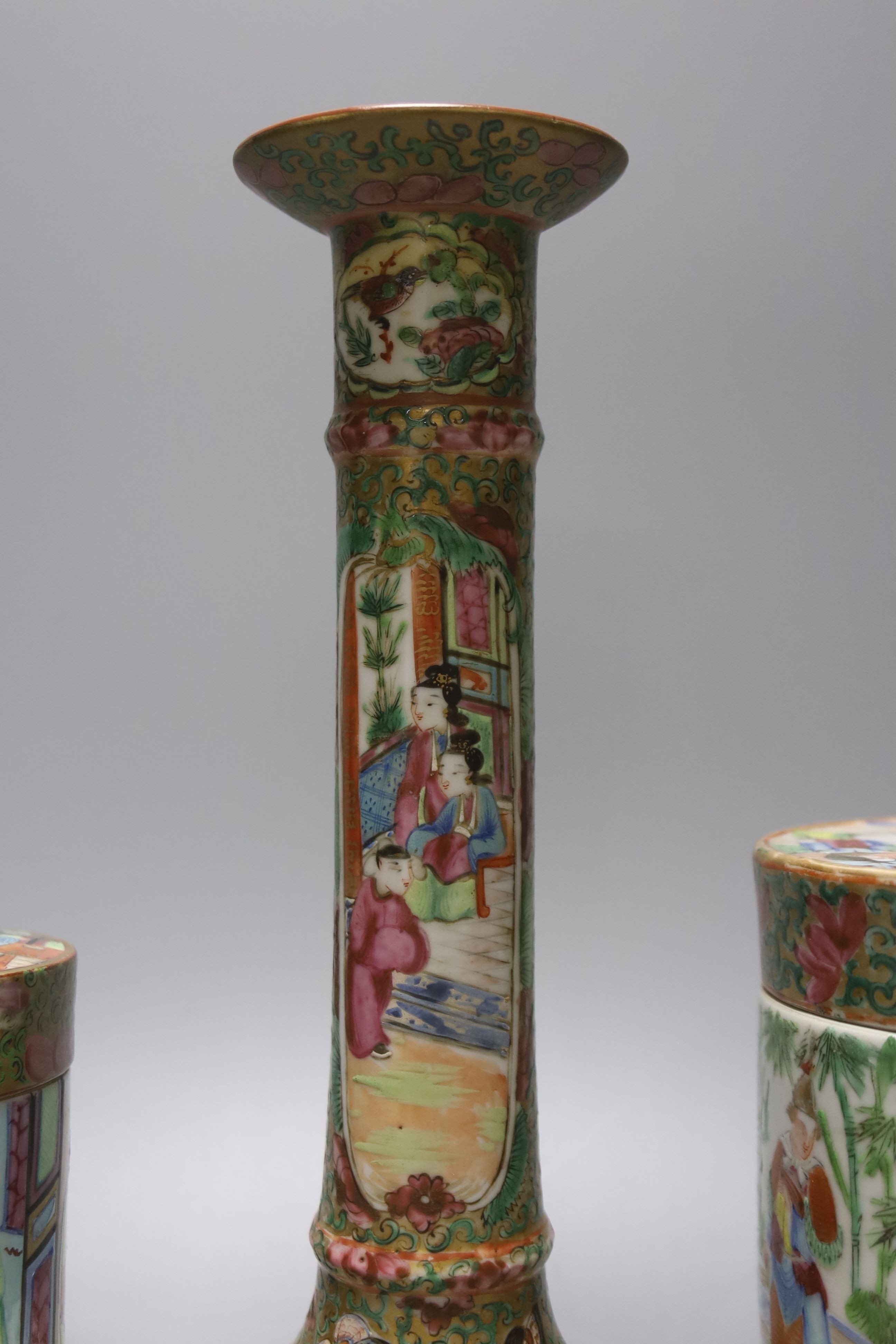 A Chinese Canton famille rose nest of boxes and covers, a similar candlestick and a tray 23cm
